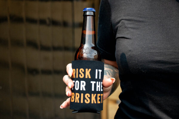 Risk It For The Brisket Beverage Holder on bottle of beer